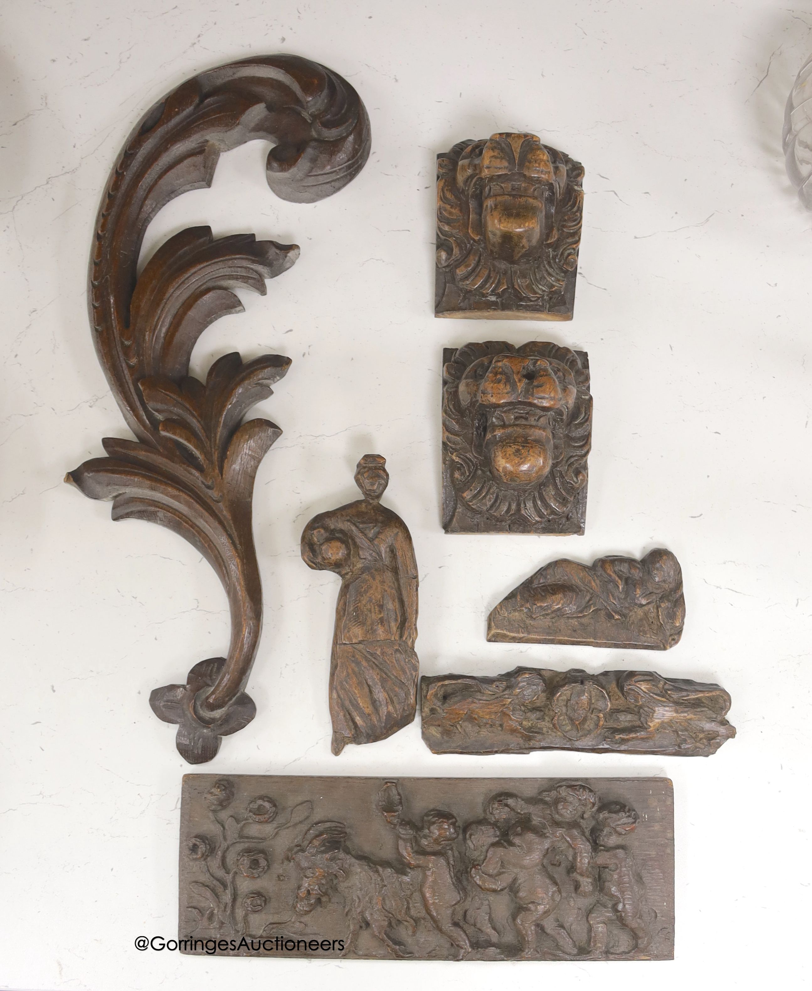 Seven 17th century or later carved oak fragments including a pair of lion masks